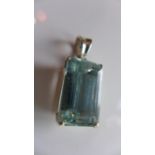 A Ladies silver pendant, inset with baguette cut Aquamarine, stamped 925 to clasp