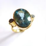 A ladies 18k yellow gold ring inset with central oval aquamarine, approx. 9ct and two brilliant