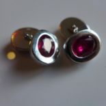 A pair of Gentlemen's 18ct white gold cufflinks, each inset with an oval cut natural Ruby (approx