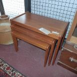 A mid 20th century teak nest of three tables