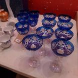 A collection of eleven blue Bohemian drinking glasses