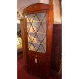 WITHDRAWN- A Regency mahogany corner cabinet, with astral glazed door, over one drawer and one