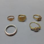 A collection of five rings, to include a gilt metal and diamond inset ring, stamped PLAT, a yellow