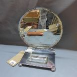 An Art Deco chrome vanity mirror, with round bevelled glass plate and glass dish on rectangular