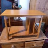 A mid 20th century teak coffee table, with magazine rack, H.43 W.61 D.35cm