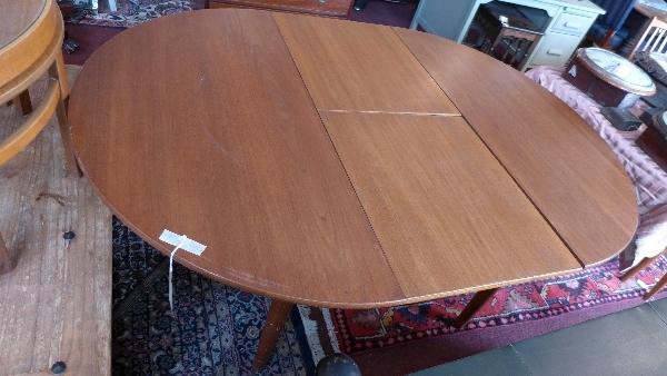 A mid 20th century Danish teak dining table, with fold in butterfly leaf, raised on tapered legs