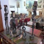 A collection of nine African wood carvings, to include three large figures of a ladies carrying