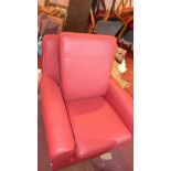 A pair of red leather contemporary armchairs