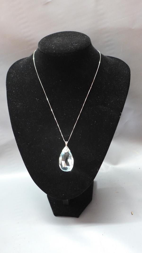 A large pear cut aquamarine pendant, with white metal mount set with diamonds