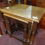 An early 20th century oak nest of three tables