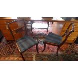 A set of six Regency style mahogany dining chairs, with brass inlay, raised on sabre legs