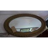 An early 20th century gilt oval mirror, with bevelled plate, 55 x 81cm