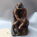 A resin figural study of two nude lovers kissing, H.11cm