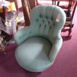 A Victorian spoon back armchair, with green linen button back upholstery, raised on turned legs