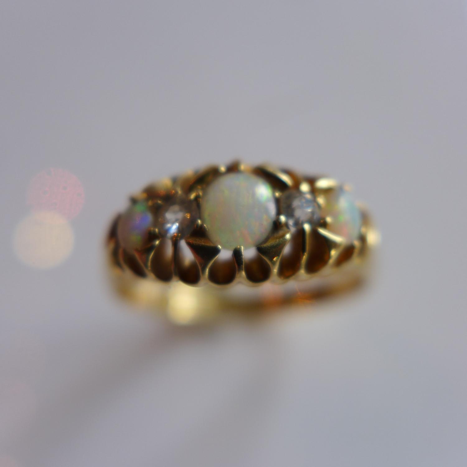 An 18ct yellow gold ladies ring inset with three opals and two diamonds, hallmarked Birmingham, L&L, - Image 2 of 2