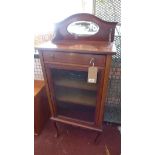 An Edwardian mahogany music cabinet, with oval mirror back plate, above one drawer and one glazed