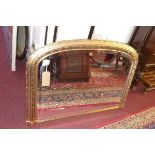 A contemporary overmantel mirror, with floral decorated frame and bevelled glass plate, H.74 W.109cm