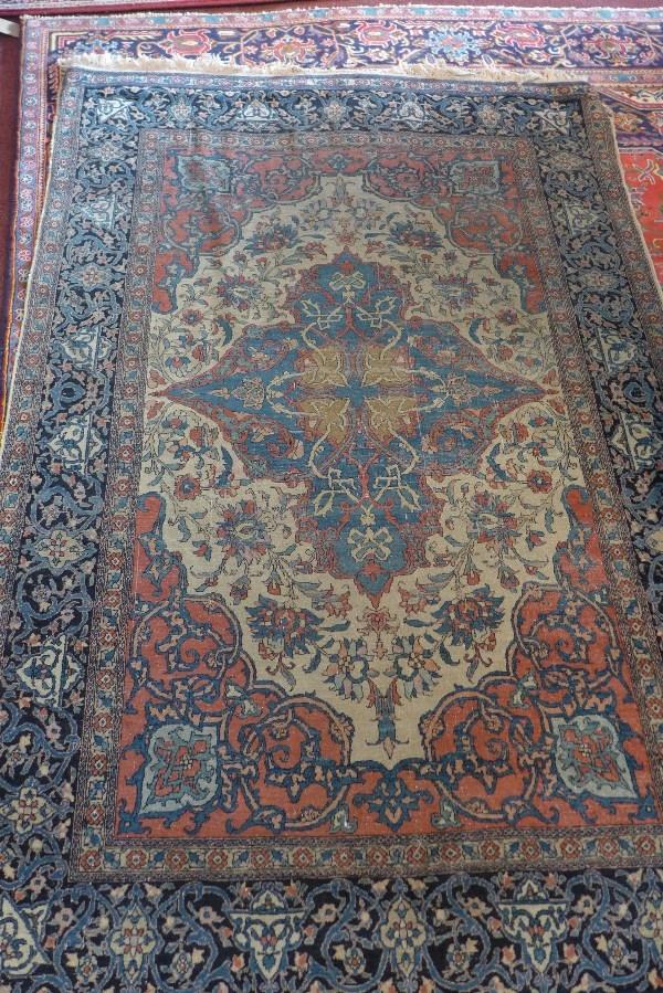 An antique Kashan carpet, with central floral medallion, contained by floral borders, 220 x 140cm