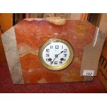 An Art Deco marble mantel clock, Arabic enamel dial, spade hands, drum movement, striking bell