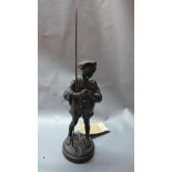 A Russian cast iron figure of a boy holding a rod, on circular base, marked CCCP to base, H.37cm