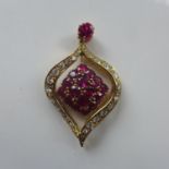 An 18ct yellow gold pendant, a single ruby above the leaf shape drop pendant being inset with