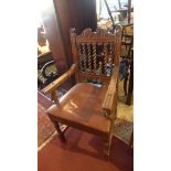 A 19th century carved oak desk chair, with barley twist back rest, brown leather seat, raised on