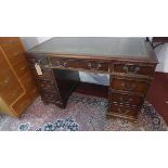 An early 20th century mahogant pedestal desk, with nine drawers, raised on bracket feet, H.77 W.