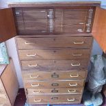 An early to mid 20th century teak laboratory cabinet, with two cupboard doors, enclosing 34 specimen