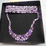 A white metal necklace mounted with many natural amethysts and some garnets, having diamond and