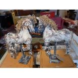 A pair of contemporary articulated horses on stands