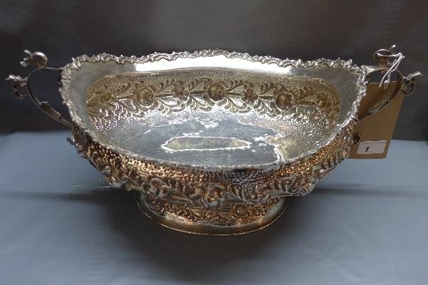 An Egyptian silver center piece, with embossed floral decoration, 55oz, H.22 W.50 D.27cm