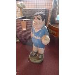 A painted stone garden figure of a Chelsea supporter