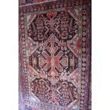 A fine old West Persian Heriz rug, central eagle motifs within stylized geometric border, 201 x