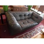 A 20th century dark brown leather sofa, with button down upholstery