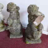 A pair of reconstituted stone cherubs seated on globes, on square bases, H.50cm