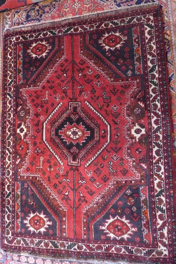 A fine South West Persian Afshar rug, central pole medallion on a terracotta field complimented by a