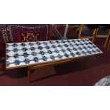 A mid 20th century 'Standart LTD' teak coffee table with tile top, raised on tapered legs, with