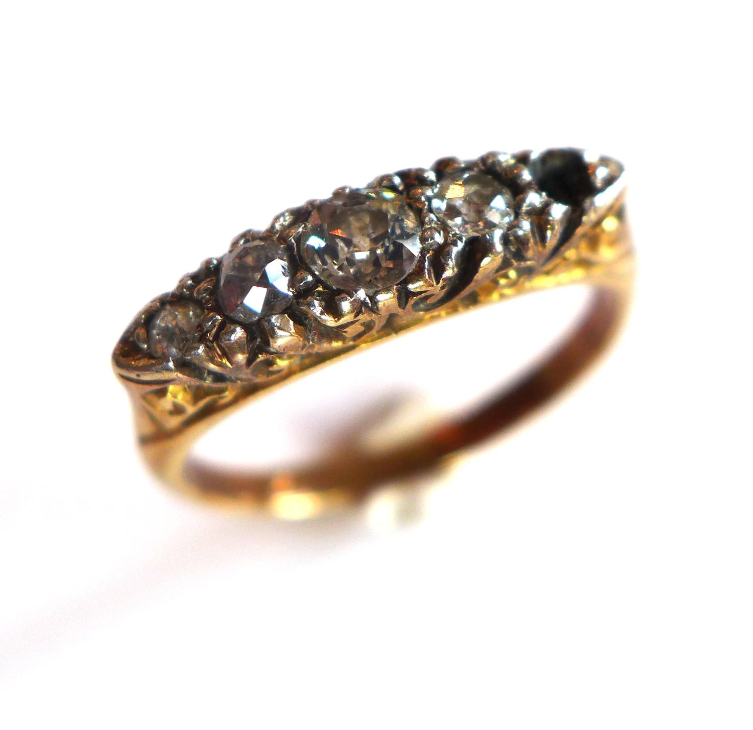 A ladies yellow metal ring, inset with four round cut diamonds (one missing), size J 1/2