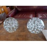 A pair of large glass paperweights/door stops, with bubble effect