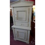 An early 20th century white painted kitchen cabinet, with two doors, one drawer, raised on stepped