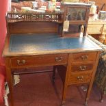 An Edwardian Maple & co mahogany writing table, with ebony and boxwood inlay, raised on tapered