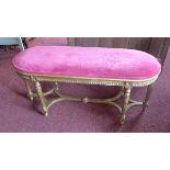 A Louis XV style giltwood window stool, with pink velour upholstered seat, raised on reeded legs,
