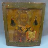 A Russian icon depicting St Nicholas of Myra, tempera on wood panel, 30 x 26cm