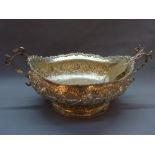 A continental silver centerpiece, twin handled, with embossed floral decoration, stamped 800,