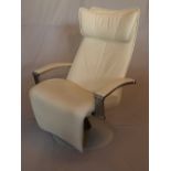 A contemporary Gravity cream leather reclining armchair, on circular base, H.115cm