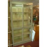 A grey painted Roche Bobois glass fronted display cabinet, with astral glazed doors, H.227 W.122 D.
