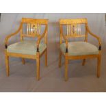 A pair of Biedermeier maple wood armchairs, raised on tapered legs