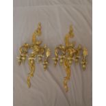 A pair of early 20th century Rococo style ormolu three branch wall lights