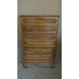 An early 20th century French walnut pedestal chest of seven drawers, raised on shaped bracket