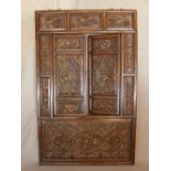 A large late 19th/early 20th century Chinese hardwood wall plaque, with two hinged doors, having